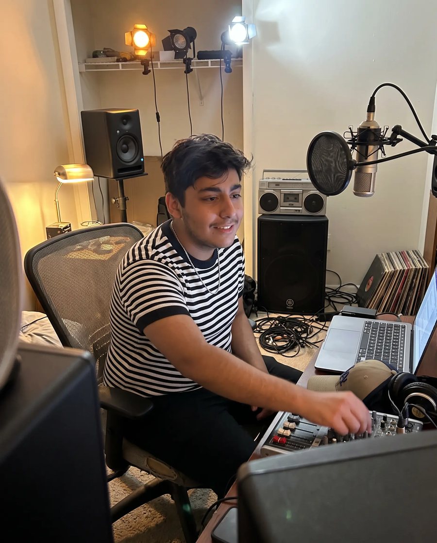Billy, cofounder of HoodRaps, at the desk of his home studio